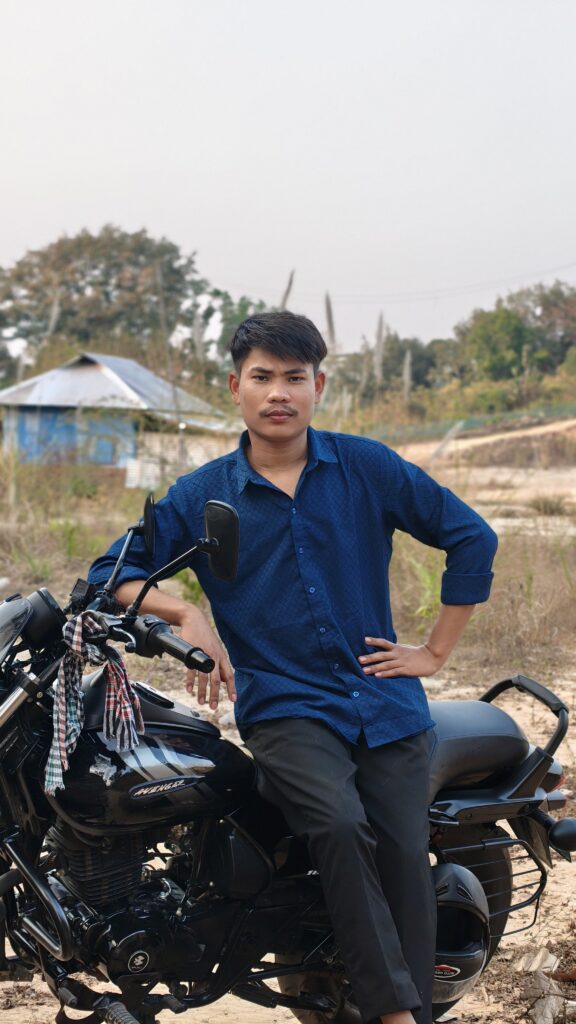 Changthak Debbarma Founder of Best Review 99 with his motorcycle